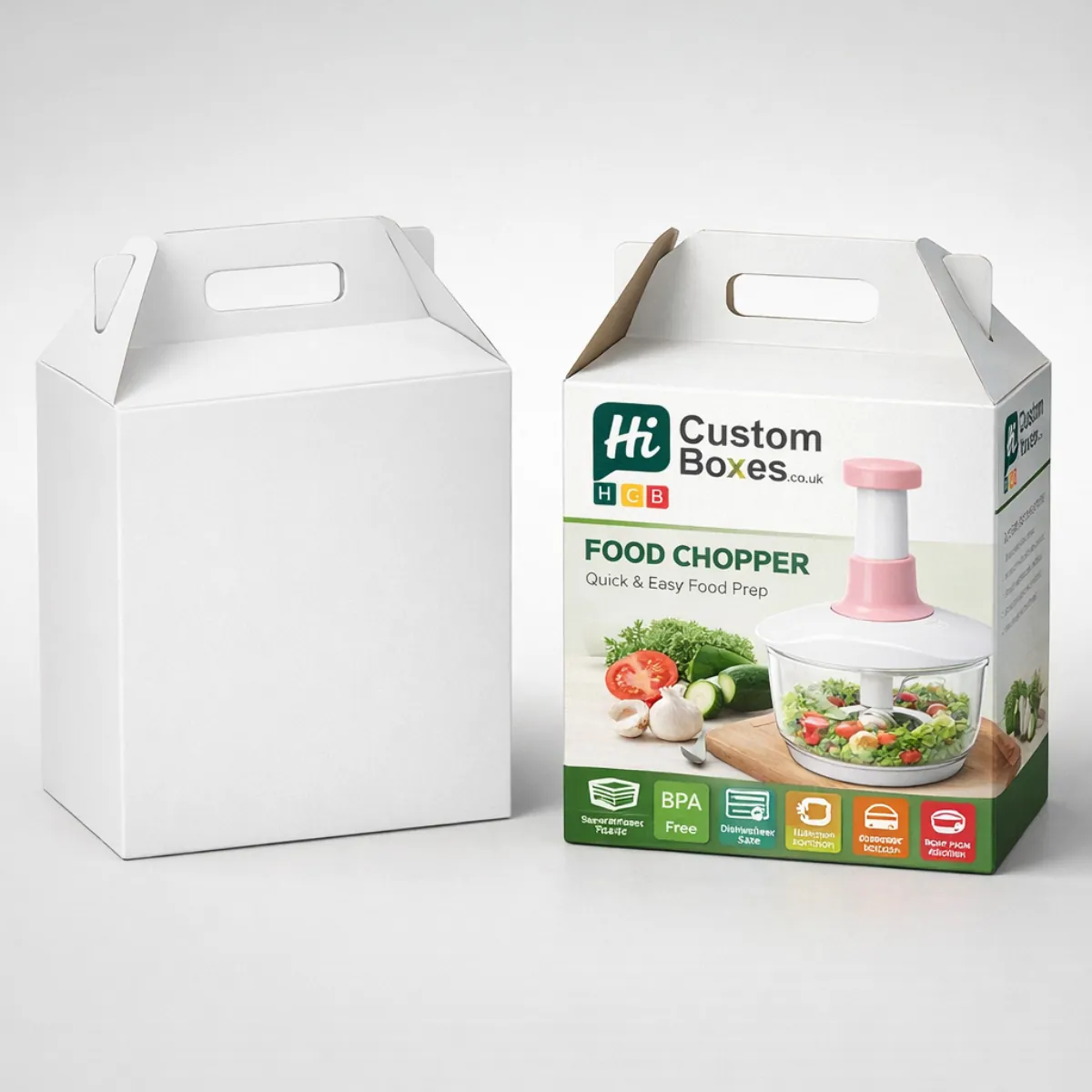 Gable-top cardboard boxes with integrated handles, featuring a pink food chopper and fresh vegetable imagery. class=